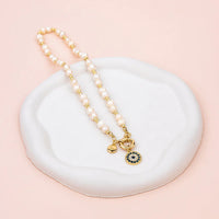 Yellow Gold Eye Pendant on Freshwater Pearl Necklace